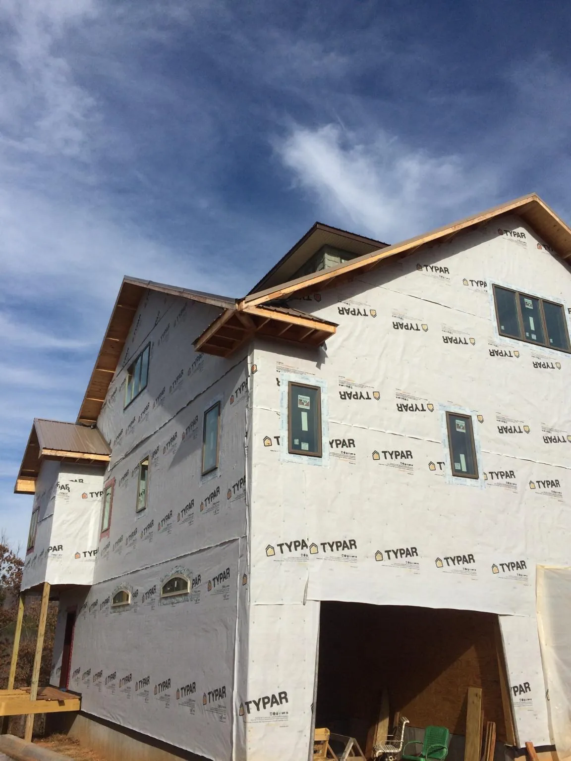 Stick built house wrapped in Typar with new roof framing and dormers in Tupelo